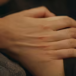 the hands of a person with their wedding ring on