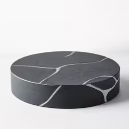 a white table topped with an artistically designed gray table