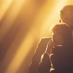 a person standing in the sun with their head resting on their arms