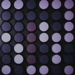 many circular blue and purple powders are arranged to form a grid