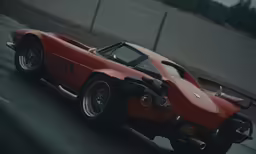 the rear of a vintage race car speeding on a road
