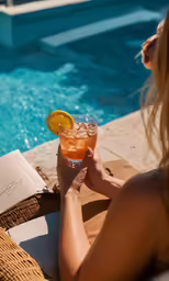 person drinking drinks near a swimming pool