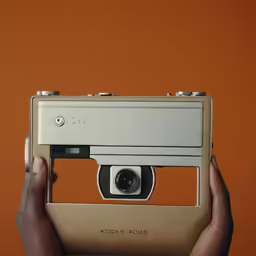 someone holding a camera in front of the camera body