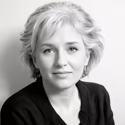 woman with short blonde hair wearing a black shirt