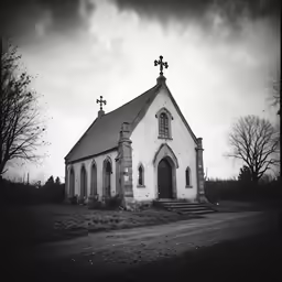 an old church on a deserted, grassy field