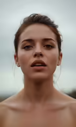 a woman with bare nipples and dark lipstick looks off into the distance