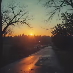 a sunrise at the end of a long road