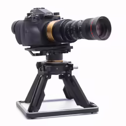 the camera that is sitting on a tripod with a lens
