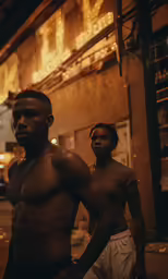 two men are standing outside one is dark and his another is white