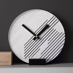 a white and black clock on top of a shelf