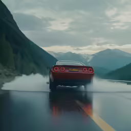 red car speeding down the road with fog coming off it