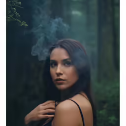 a woman in the woods smoking a cigarette