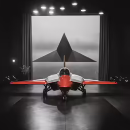 an airplane is sitting alone in a darkened room