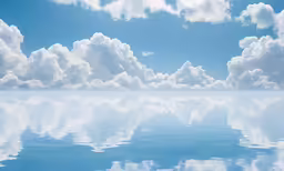 a large body of water under a partly cloudy sky