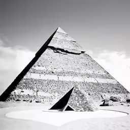 a tall stone pyramid in the desert near a cloudless sky