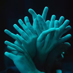 the hands have the blue glow from a dark background