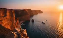 a boat in the ocean near large cliffs
