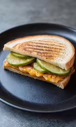 a sandwich with cucumber and cheese on a plate