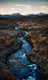 a stream flows through a rocky landscape into the wild