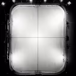 lights in the top of a large mirror reflecting on it