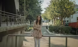 a beautiful young woman posing on a railing