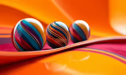 two shiny, artistically decorated eggs sit atop the vivid backdrop