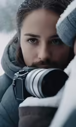 a girl is taking a picture in the snow