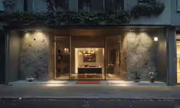 a hotel entrance with lighting on either side