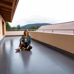 a woman is sitting on the floor of an empty building