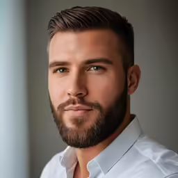 a man with a beard and white shirt