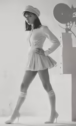 woman in tight white shorts and hat posing