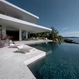 a modern house sitting near an ocean