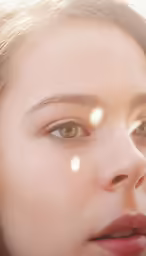 a girl with brown eyes and bright makeup