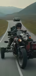 a man riding a motorcycle on the road