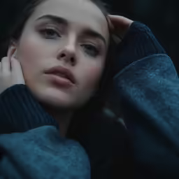 a woman with her head up is wearing a sweater