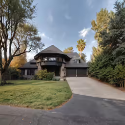 the front of a house that is on the corner of a road