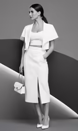 a woman in a white dress and jacket is standing against a wall