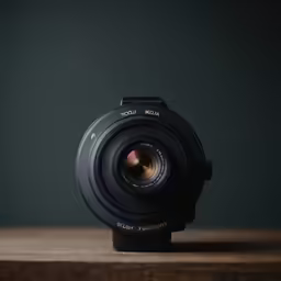 a camera lens sitting on top of a wooden table