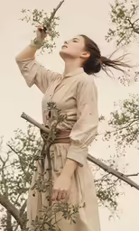a woman in a dress holding a plant in a tree
