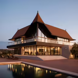 the front side of a house with a pool in front of it