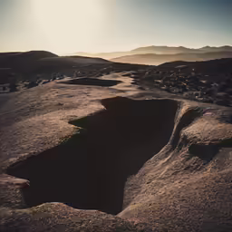 the large hole in the ground is very dark