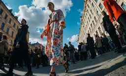 people are gathered on a sidewalk while dressed in elegant clothing