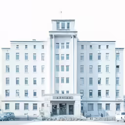 a large white building sitting in the middle of a road