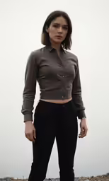 a woman in black pants and a dark shirt