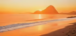 the sun sets on the beach and water