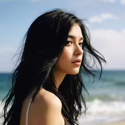 a woman in a bathing suit on the beach
