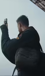 there is a man taking pictures with his phone