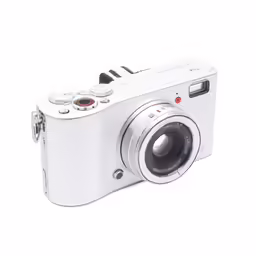 a white camera sitting on top of a white table