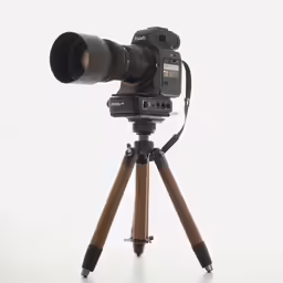 a camera is shown on a tripod on white