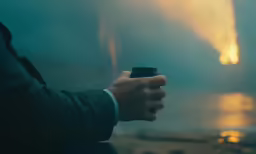 man holding a camera in the middle of the night